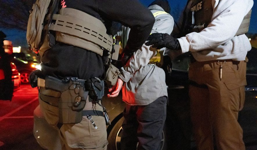 U.S. Immigration and Customs Enforcement officers detain a person, Jan. 27, 2025, in Silver Spring, Md. (AP Photo/Alex Brandon, File)