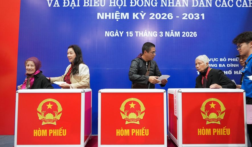 Voters cast ballots to elect representatives in the National Assembly and people's councils in Hanoi, Vietnam, Sunday, March 15, 2026. (AP Photo/Hau Dinh)