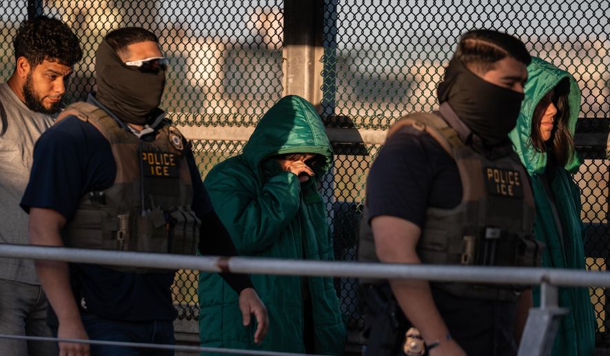 A group of undocumented migrants is deported by U.S. Immigration and Customs Enforcement agents across the McAllen–Hidalgo–Reynosa International Bridge in McAllen, Texas, on Friday, March 13, 2026. Dozens of migrants from countries including Cuba, Venezuela, Haiti, China, Guatemala and El Salvador were handed over to Mexican authorities. (AP Photo/Felix Marquez) ** FILE **