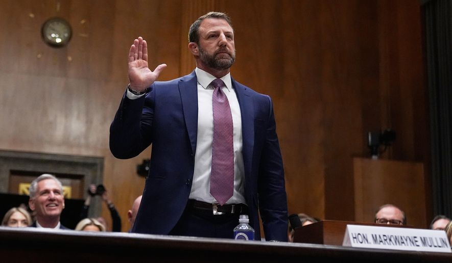 Sen. Markwayne Mullin, R-Okla., President Donald Trump's pick for Homeland Security secretary, is sworn in before testifying during Senate Committee on Homeland Security and Governmental Affairs hearing, Wednesday, March 18, 2026 on Capitol Hill in Washington. (AP Photo/Manuel Balce Ceneta)