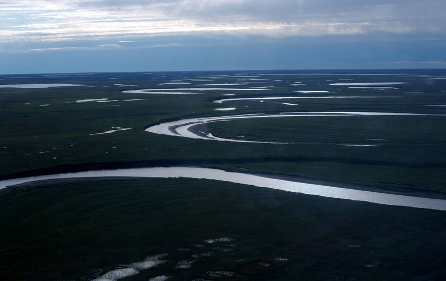 This file photo provided by the United States Geological Survey shows Fish Creek through the National Petroleum Reserve-Alaska, managed by the Bureau of Land Management, on Alaska's North Slope on July 8, 2004. (David W. Houseknecht/United States Geological Survey via AP, File)