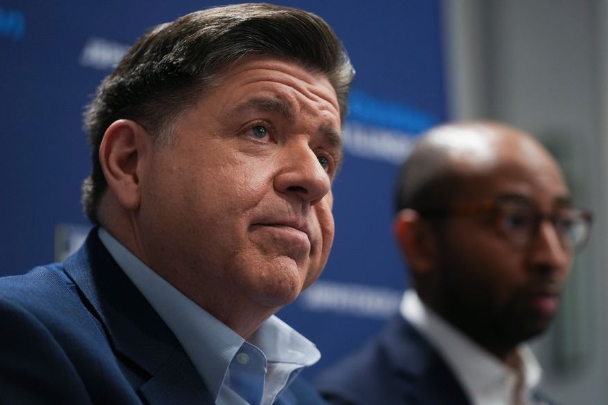 Illinois Gov. JB Pritzker, left, and running mate, candidate for lieutenant governor, Christian Mitchell speak during an interview, Wednesday, March 18, 2026, in Chicago. (AP Photo/Erin Hooley)