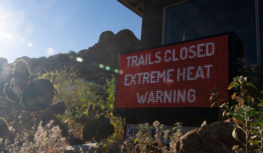 A sign warns hikers of trail closures due to extreme heat at Camelback Mountain on Thursday, March 19, 2026, in Phoenix. (AP Photo/Rebecca Noble)