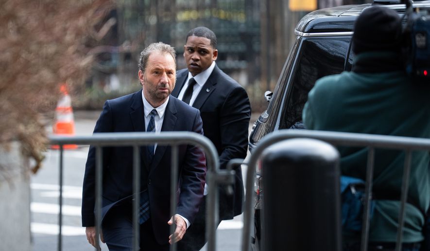 Michael Rapino, left, chief executive officer and president of Live Nation Entertainment Inc., arrives at Manhattan Federal court, Thursday, March 19, 2026 in New York. (AP Photo/Adam Gray)