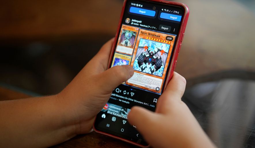 A boy uses a social media platform in Brasilia, Brazil, Thursday, March 19, 2026. A new law regulating children’s use of social media took effect this week, requiring users under 16 to link their accounts to a legal guardian. (AP Photo/Eraldo Peres)