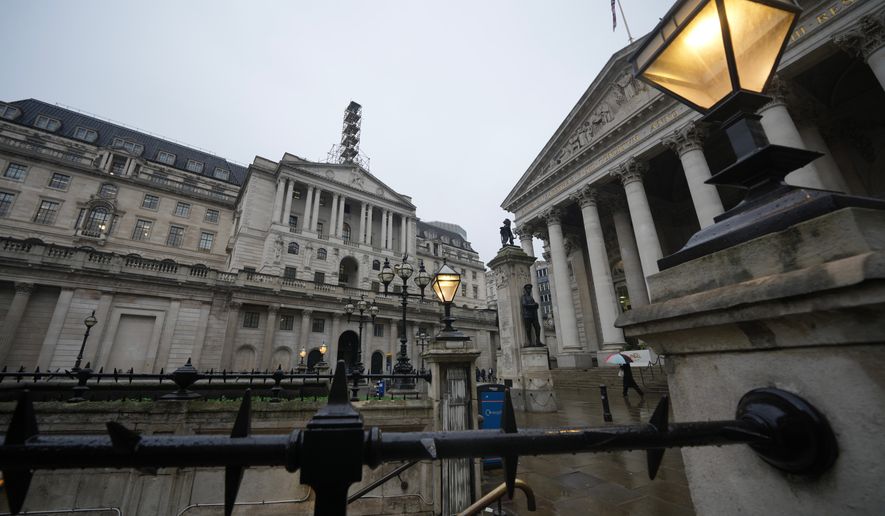 FILE -A man walks in front of the Bank of England, at the financial district in London, Feb. 5, 2026 (AP Photo/Kin Cheung, File)