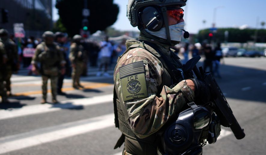 An ICE Special Response Team member stands guard outside the Metropolitan Detention Center, while protesters gather outside to denounce the ICE, U.S. Immigration and Customs Enforcement, operations, Tuesday, June 10, 2025, in downtown Los Angeles. (AP Photo/Eric Thayer, File)