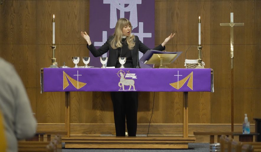 Rev. Sarah Trone Garriott, a Lutheran pastor and Iowa state senator, celebrates communion at Grace Lutheran Church in Des Moines, Iowa on Sunday, March 15, 2026. (AP Photo/Krysta Fauria)