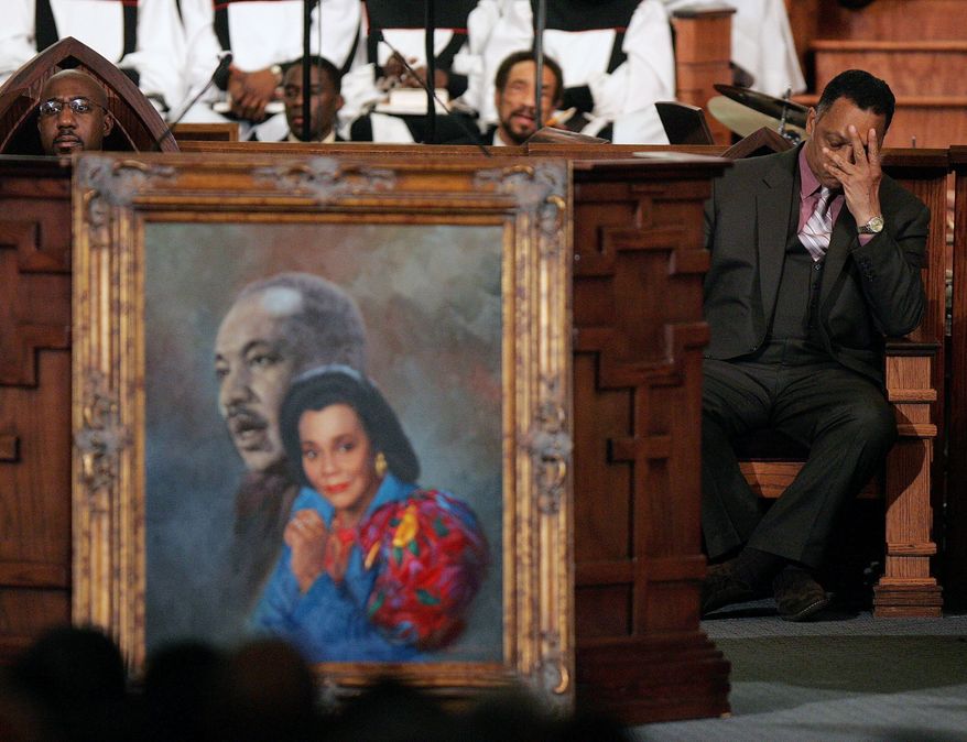 Rev. Jesse Jackson, right, reacts during a prayer service for Coretta Scott King at the new Ebenezer Church on Auburn Ave. in Atlanta Monday, Feb. 6, 2006. Ebenezer Pastor Rev. Raphael Warnock is at left. (AP Photo/John Bazemore, Pool, File)