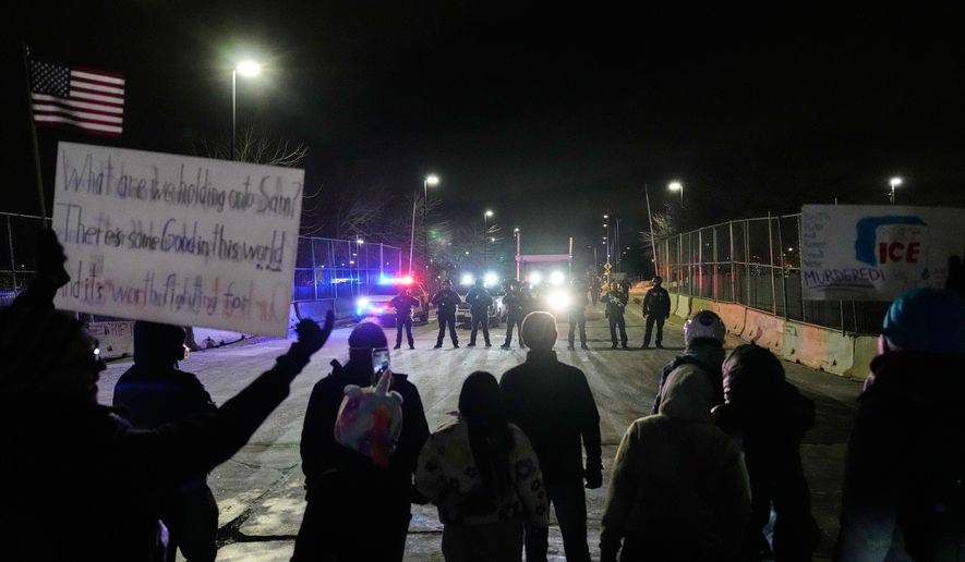 Federal immigration officers confront protesters outside Bishop Henry Whipple Federal Building in Minneapolis, on Thursday, Jan. 15, 2026. (AP Photo/Yuki Iwamura, File)