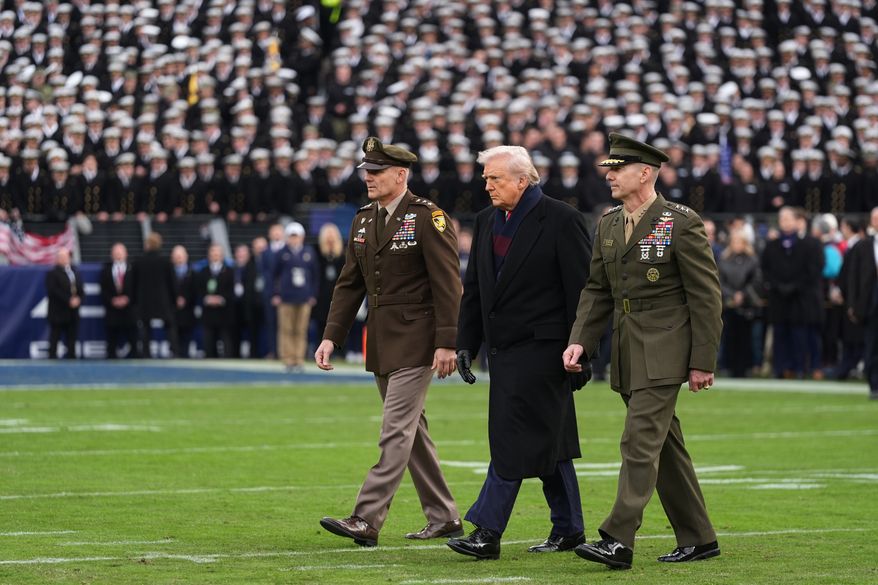 President Donald Trump is escorted onto the field to take part in the ceremonial coin toss before the start of the NCAA college football game between Army and Navy at M&T Bank Stadium in Baltimore on Saturday, Dec. 13, 2025. (AP Photo/Stephanie Scarbrough) **FILE**