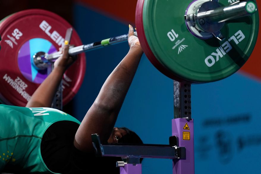 Thamar Gisele Mengue of Cameroon prepares to lift the weights during the women's heavyweight para powerlifting final at the Commonwealth Games at The NEC in Birmingham, England, Thursday, Aug. 4, 2022. (AP Photo/Aijaz Rahi,File)