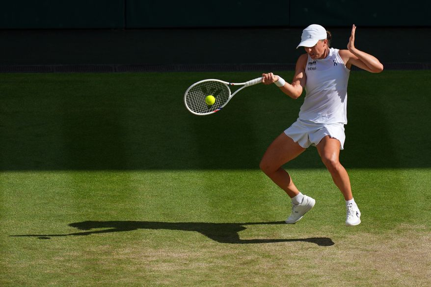 Iga Swiatek of Poland returns to Amanda Anisimova of the U.S. during the women's singles final match at the Wimbledon Tennis Championships in London, July 12, 2025.(AP Photo/Joanna Chan, File)