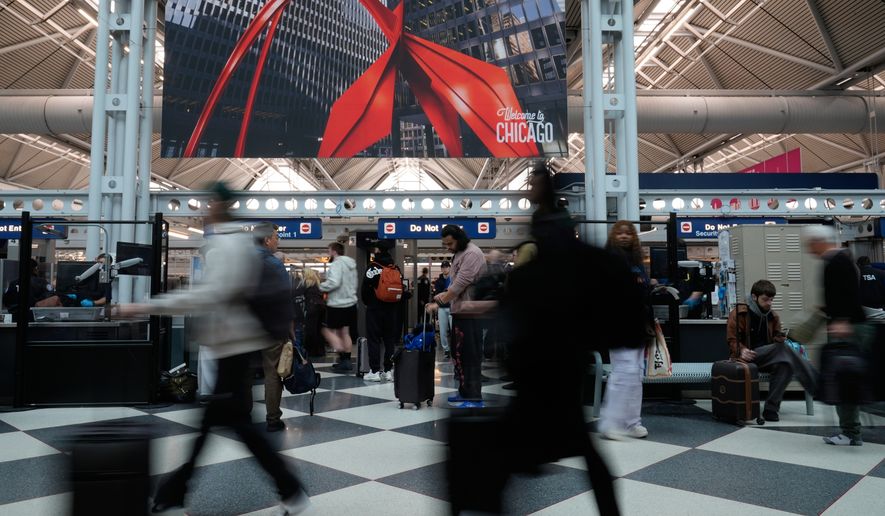Travelers go through TSA security check at O'Hare International Airport, Saturday, March 21, 2026, in Chicago. (AP Photo/Kiichiro Sat0)
