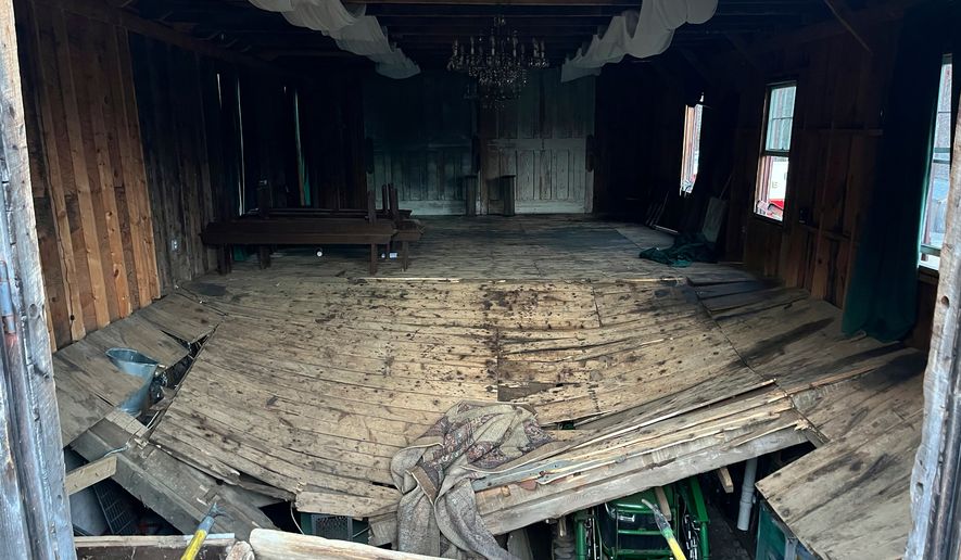 A photo provided by the New Hampshire State Fire Marshal's Office shows the buckled floor that collapsed Saturday, sending nearly 70 wedding guests into the basement of a building in Tamworth, N.H. Saturday, March 21, 2026. Six people were taken to the hospital with non-life-threatening injuries. (New Hampshire State Fire Marshal's Office via AP)