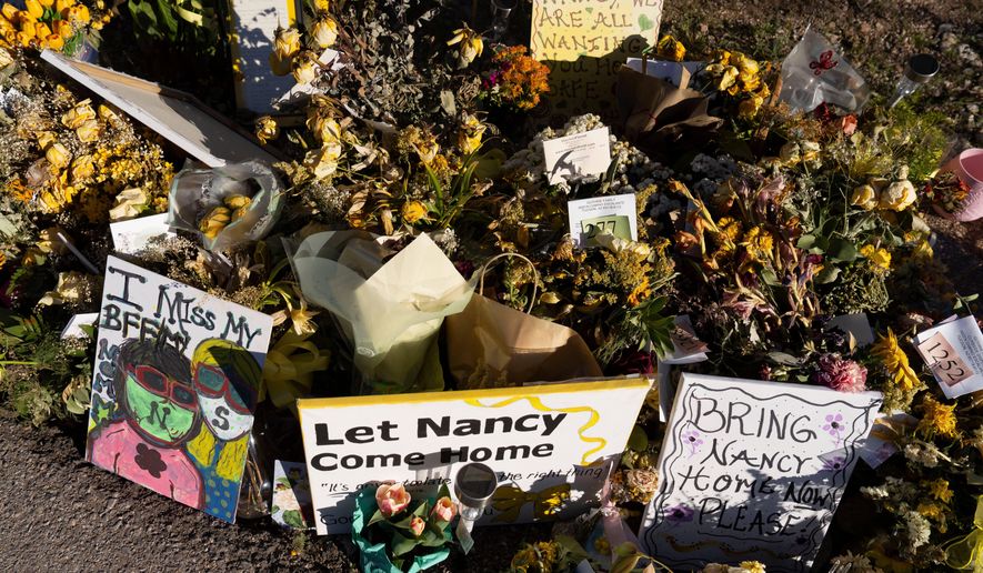 An ever-growing collection of yellow flowers and notes sit at the home of Nancy Guthrie, the missing mother of "Today" show host Savannah Guthrie, on March 6, 2026, in Tucson, Ariz. (AP Photo/Rebecca Noble, File)