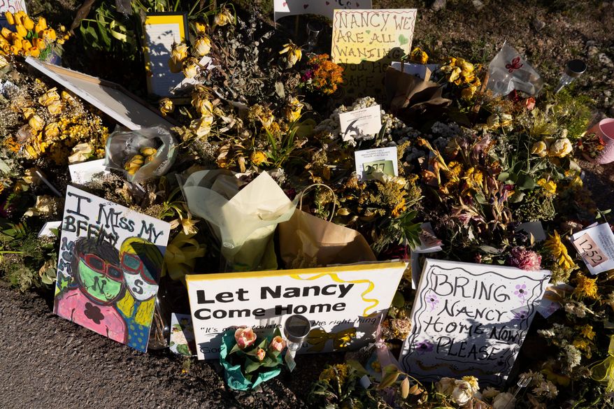 An ever-growing collection of yellow flowers and notes sit at the home of Nancy Guthrie, the missing mother of "Today" show host Savannah Guthrie, on March 6, 2026, in Tucson, Ariz. (AP Photo/Rebecca Noble, File)