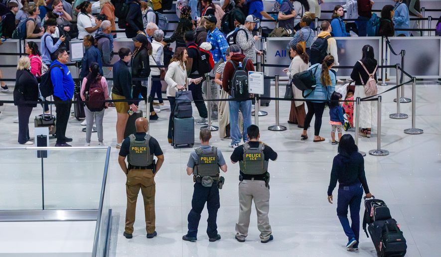 U.S. Immigration and Customs Enforcement (ICE) agents patrol Louis Armstrong International Airport in Kenner, La., Monday, March 23, 2026. (David Grunfeld/The New Orleans Advocate via AP)