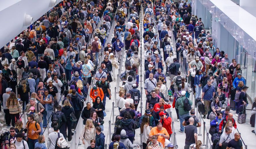 Travelers navigate their way through the TSA screening process lines at Louis Armstrong International Airport in Kenner, La. near New Orleans, Monday, March 23, 2026. (David Grunfeld/The New Orleans Advocate via AP)