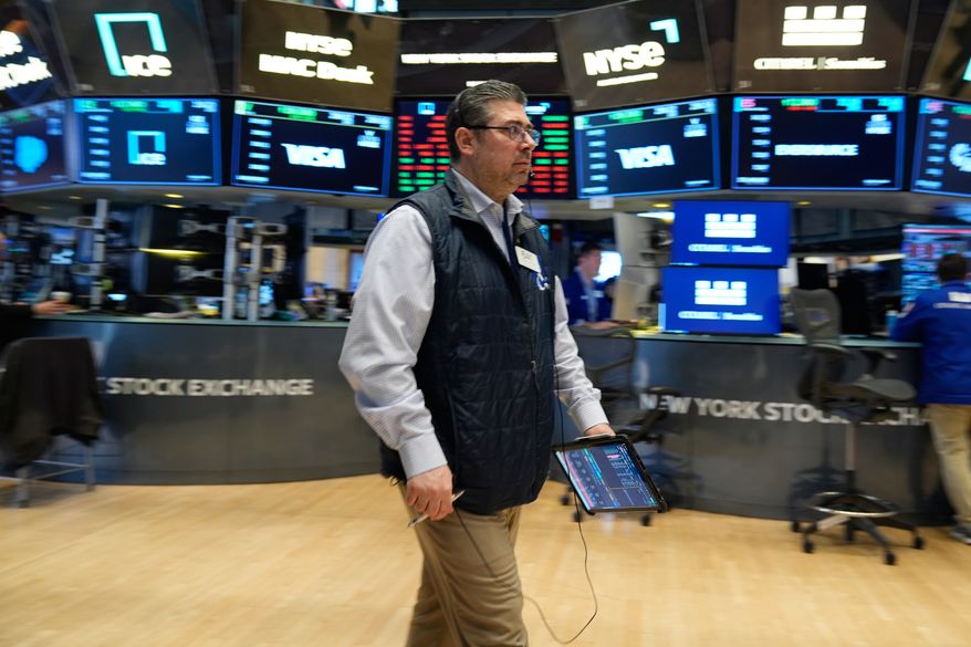 Michael Capolino works on the floor at the New York Stock Exchange in New York, Thursday, March 19, 2026. (AP Photo/Seth Wenig)