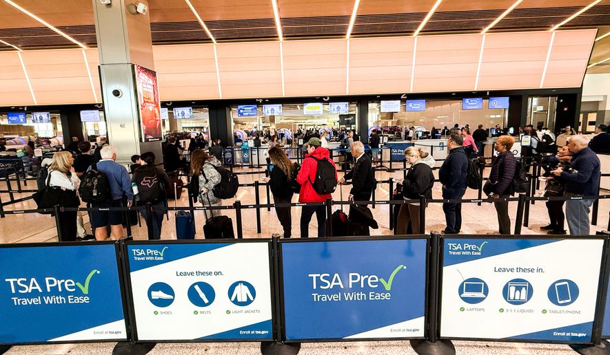 People wait in a TSA security line at Terminal A of Newark Liberty International Airport (EWR) in Newark, N.J., U.S., Tuesday, March 24, 2026. (AP Photo/Eduardo Munoz Alvarez)