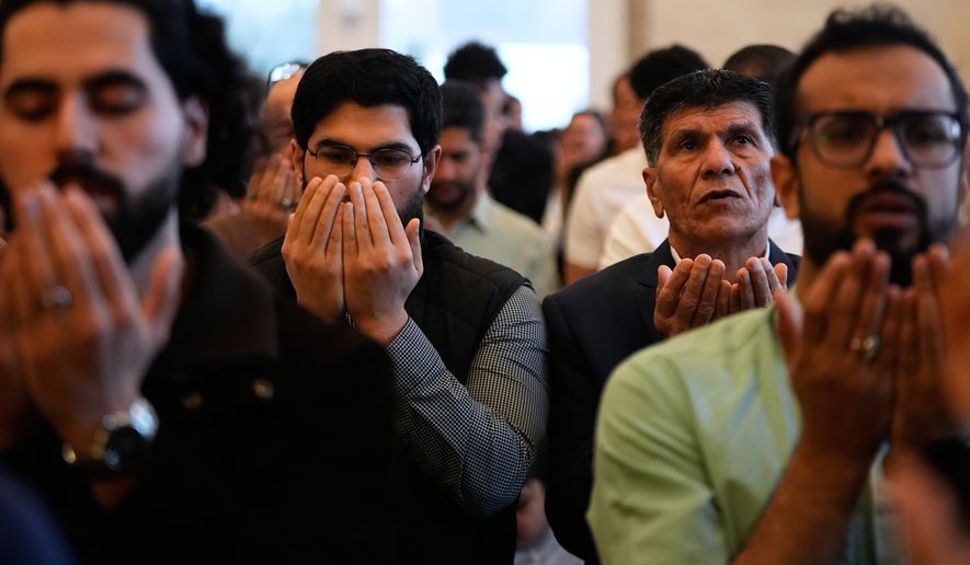 Muslim worshippers attend Eid al-Fitr prayer at the Islamic Institute of America Friday, March 20, 2026, in Dearborn Heights, Mich. (AP Photo/Paul Sancya)
