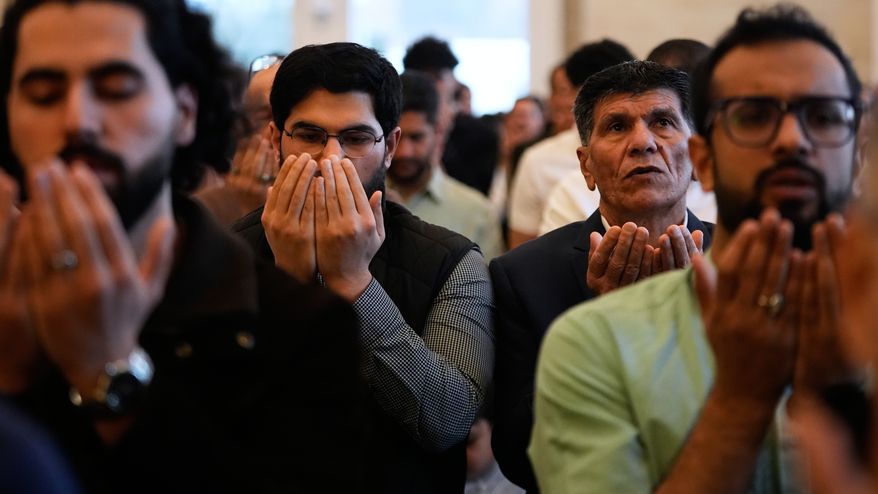 Muslim worshippers attend Eid al-Fitr prayer at the Islamic Institute of America Friday, March 20, 2026, in Dearborn Heights, Mich. (AP Photo/Paul Sancya)