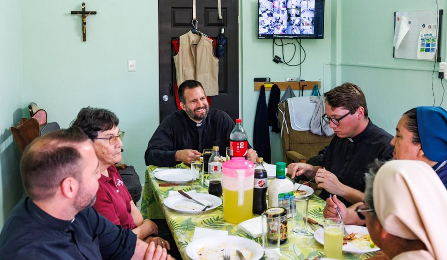 The Rev. Brian Strassburger enjoys lunch alongside fellow Jesuits and religious sisters at Casa del Migrante on Thursday, March 19, 2026, in Reynosa, Mexico. (AP Photo/Michael Gonzalez)