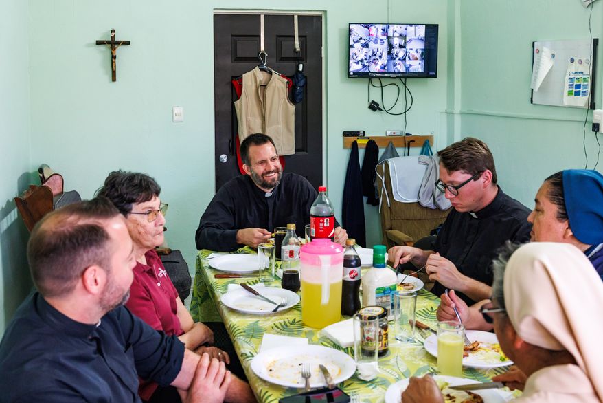 The Rev. Brian Strassburger enjoys lunch alongside fellow Jesuits and religious sisters at Casa del Migrante on Thursday, March 19, 2026, in Reynosa, Mexico. (AP Photo/Michael Gonzalez)