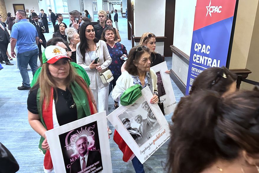 Supporters of the war in Iran arrive at the Conservative Political Action Conference in Grapevine, Texas, Wednesday, March 25, 2026, as the annual gathering of thousands of conservatives from around the country and overseas begins. (AP Photo/Thomas Beaumont)