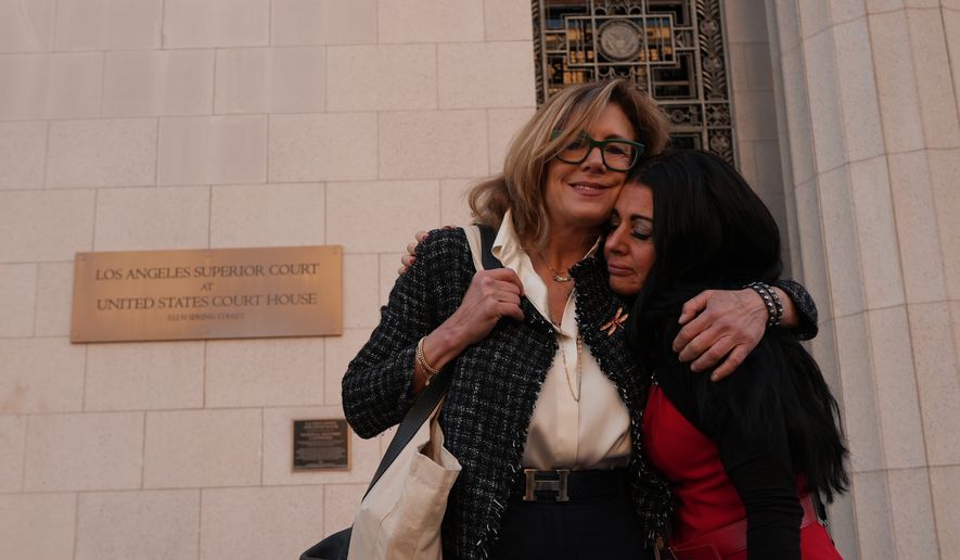 Julianna Arnold, left, mother and advocate for online child safety after her 17-year-old daughter, Coco, died in 2022 from fentanyl poisoning following a social media encounter, hugs Mandi Furniss, parent of LJ, 18, from East Texas before they enter court for closing arguments in a landmark trial over whether social media platforms deliberately addict and harm children at Los Angeles Superior Court in Los Angeles Thursday, March. 12, 2026. (AP Photo/Damian Dovarganes) **FILE**