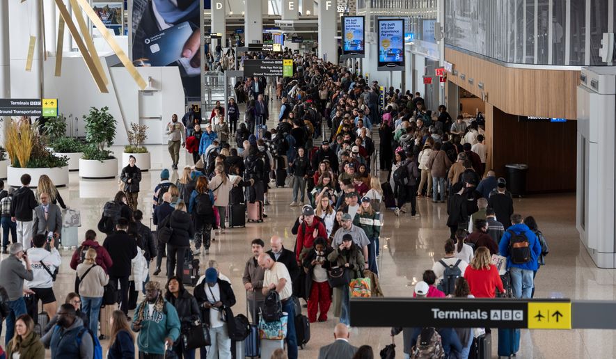 Travelers wait in a TSA line, Wednesday, March 25, 2026, at LaGuardia Airport in New York. (AP Photo/Yuki Iwamura)
