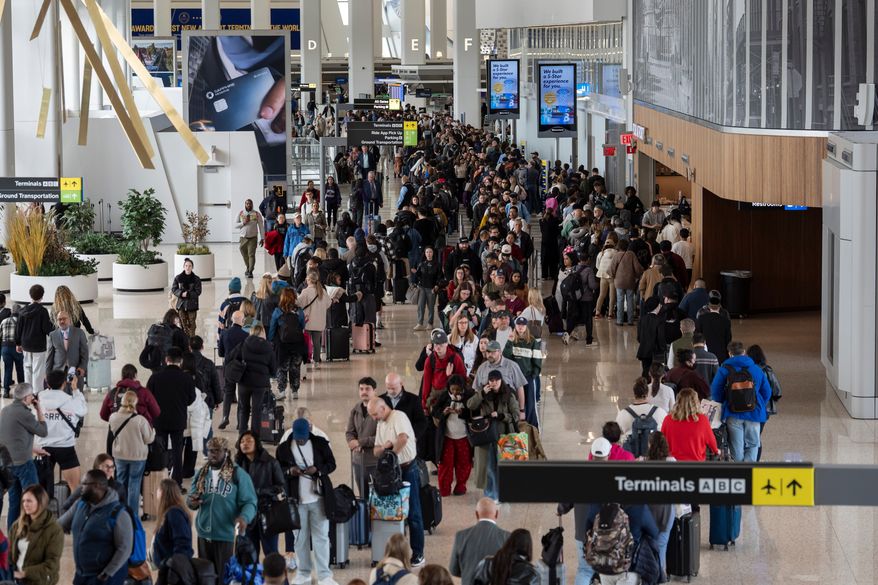 Travelers wait in a TSA line, Wednesday, March 25, 2026, at LaGuardia Airport in New York. (AP Photo/Yuki Iwamura)