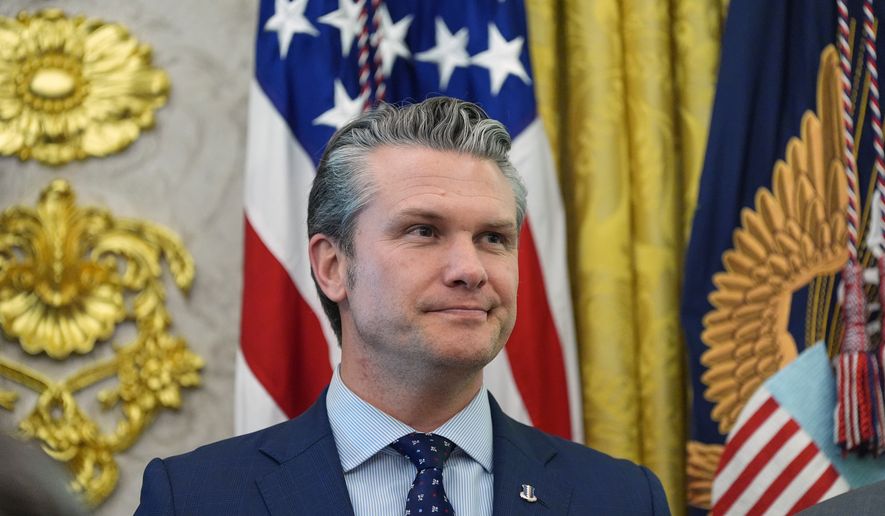 Defense Secretary Pete Hegseth listens as President Donald Trump speaks during the swearing in for Homeland Security Secretary Markwayne Mullin in the Oval Office of the White House, Tuesday, March 24, 2026, in Washington. (AP Photo/Alex Brandon)