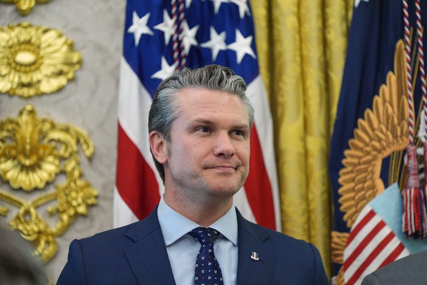 Defense Secretary Pete Hegseth listens as President Donald Trump speaks during the swearing in for Homeland Security Secretary Markwayne Mullin in the Oval Office of the White House, Tuesday, March 24, 2026, in Washington. (AP Photo/Alex Brandon)