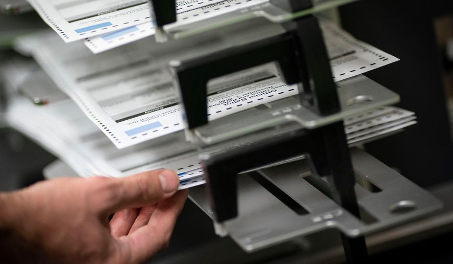 FILE - Poll workers sort ballots at the Kenosha Municipal Building on Election Day, Nov. 3, 2020, in Kenosha, Wis. (AP Photo/Wong Maye-E, File)