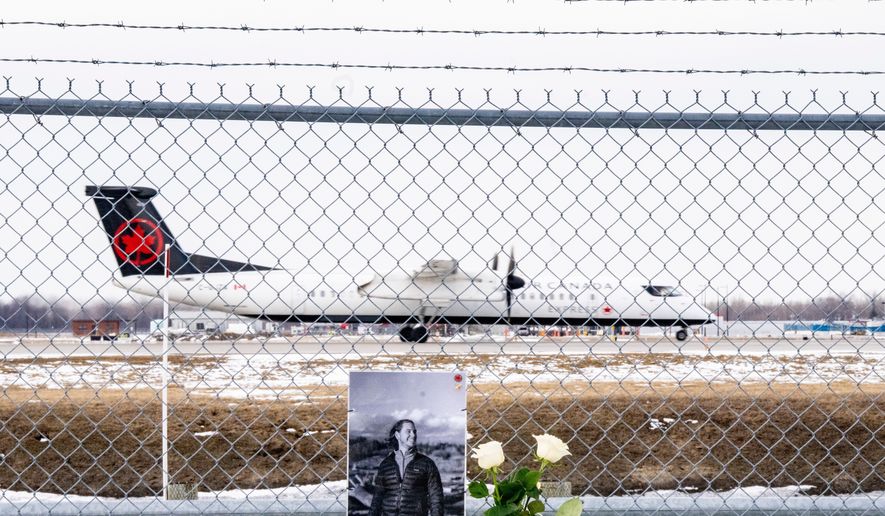 An Air Canada Express plane takes off in Montreal, on Wednesday, March 25, 2026, wldbehind a memorial for Air Canada Jazz pilot Antoine Forest, who died when his plane collided with an emergency vehicle at New York's LaGuardia Airport. (Christinne Muschi/The Canadian Press via AP)