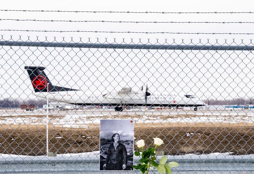 An Air Canada Express plane takes off in Montreal, on Wednesday, March 25, 2026, wldbehind a memorial for Air Canada Jazz pilot Antoine Forest, who died when his plane collided with an emergency vehicle at New York's LaGuardia Airport. (Christinne Muschi/The Canadian Press via AP)