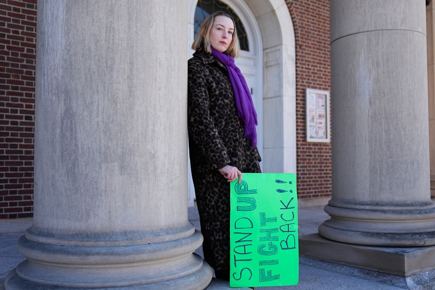 Allison Posner, an organizer for an upcoming "No Kings" protest poses for a photo on the steps of the town hall in Maplewood, N.J., Tuesday, March 24, 2026. (AP Photo/Seth Wenig)