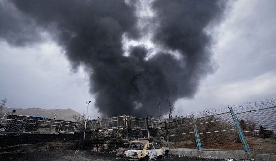 A thick plume of smoke rises from an oil storage facility hit by a U.S.-Israeli strike in Tehran, Iran, March 8, 2026. (AP Photo/Vahid Salemi, File)