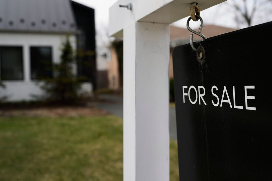 A House For Sale sign is displayed in front of a home in Evanston, Ill.,Wednesday, March 25, 2026. (AP Photo/Nam Y. Huh)