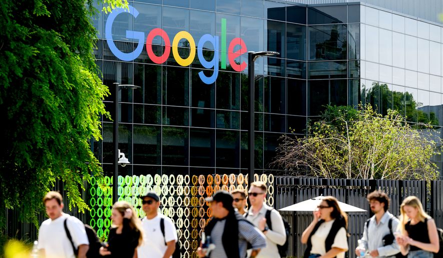 People walk through Google headquarters in Mountain View, Calif., on Thursday, March 26, 2026. (AP Photo/Noah Berger)