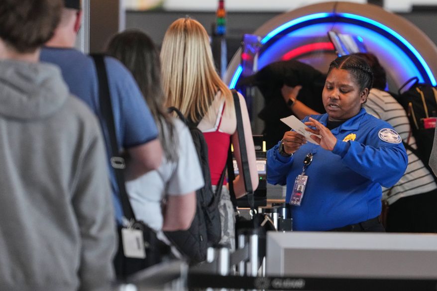 A TSA worker checks passengers at Greater Pittsburgh International Airport in Imperial, Pa., Thursday, March 26, 2026. (AP Photo/Gene J. Puskar)