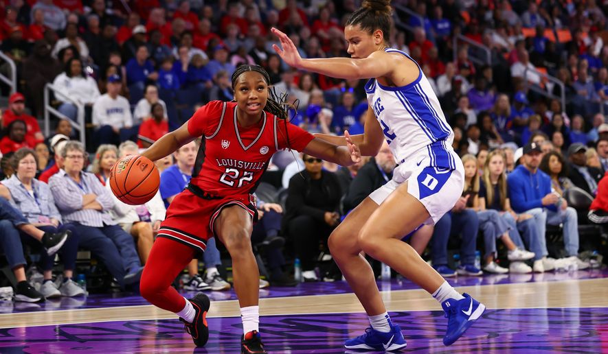 Louisville guard Tajianna Roberts (22) dribbles against Duke forward Delaney Thomas (12) during the first half of an NCAA college basketball game in the championship of the Atlantic Coast Conference tournament, Sunday, March 8, 2026, in Duluth, Ga. (AP Photo/Colin Hubbard)