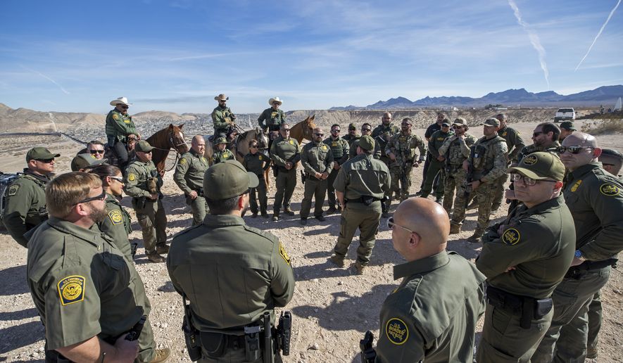 Border Patrol Chief Michael Banks, center back to the camera, speaks to fellow agents during the visit to the U.S. and Mexico border by Defense Secretary Pete Hegseth in Sunland Park, N.M., Monday, Feb. 3, 2025. (AP Photo/Andres Leighton)