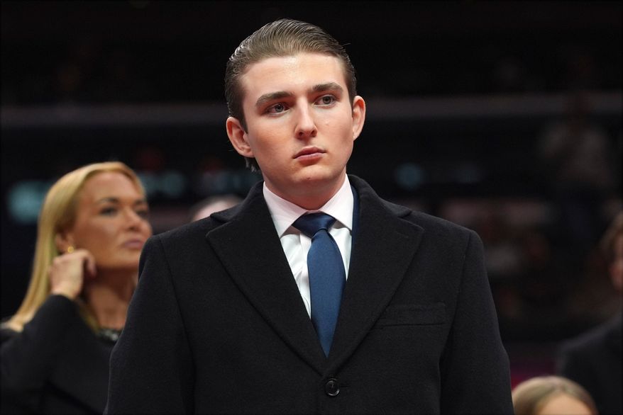 Barron Trump watches as his father, President Donald Trump attends an indoor Presidential Inauguration parade event at Capital One Arena, in Washington, Jan. 20, 2025. (AP Photo/Evan Vucci, File)
