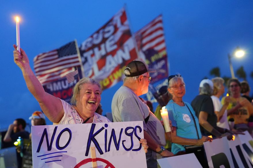 FILE - Dee Cahill of Margate, Fla., holds a "No Kings" sign as she participates in a pro-democracy, anti-Trump protest outside Trump's Mar-a-Lago estate in Palm Beach, Fla., as part of the "Good Trouble Lives On" national day of action, July 17, 2025. (AP Photo/Rebecca Blackwell, File)