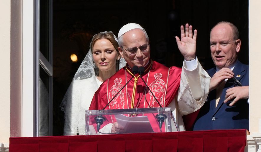 Pope Leo XIV, Princess Charlene of Monaco and Prince Albert II of Monaco appear at the Gallery of Hercules balcony at the Prince's Palace in Monaco-Ville, Monaco, Saturday, March 28, 2026.(AP Photo/Gregorio Borgia)