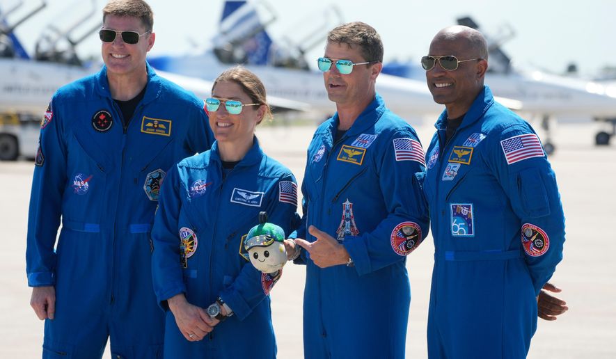 Artemis 2 crew members, from left, Mission Spc. Jeremy Hansen, of Canada, Mission Spc. Christina Koch, Commander Reid Wiseman, and Pilot Victor Glover pose for a photo after the crew's arrival at the Kennedy Space Center Friday, March 27, 2026, in Cape Canaveral, Fla. (AP Photo/Chris O'Meara)