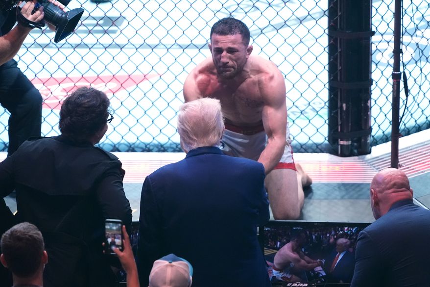 President Donald Trump congratulates Georgia's Merab Dvalishvili, after he won his bantamweight title bout against Sean O'Malley, during the UFC-316 mixed martial arts event, at the Prudential Center, June 7, 2025, in Newark, N.J. (AP Photo/Manuel Ceneta, File)